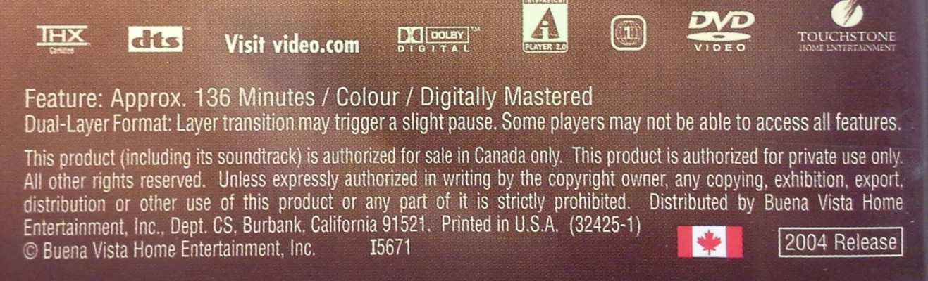 Back side of the packaging of a dual-layered DVD movie disc showing the statement that there will be a slight pause as the laser transitions between the information layers of the DVD.