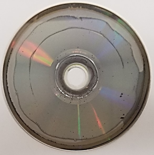 Laser rot or disc rot on a DVD movie disc. The metal of the DVD disc has oxidized and caused the formation of holes in the metal as well as non-uniformity and thinning of the metal layer.