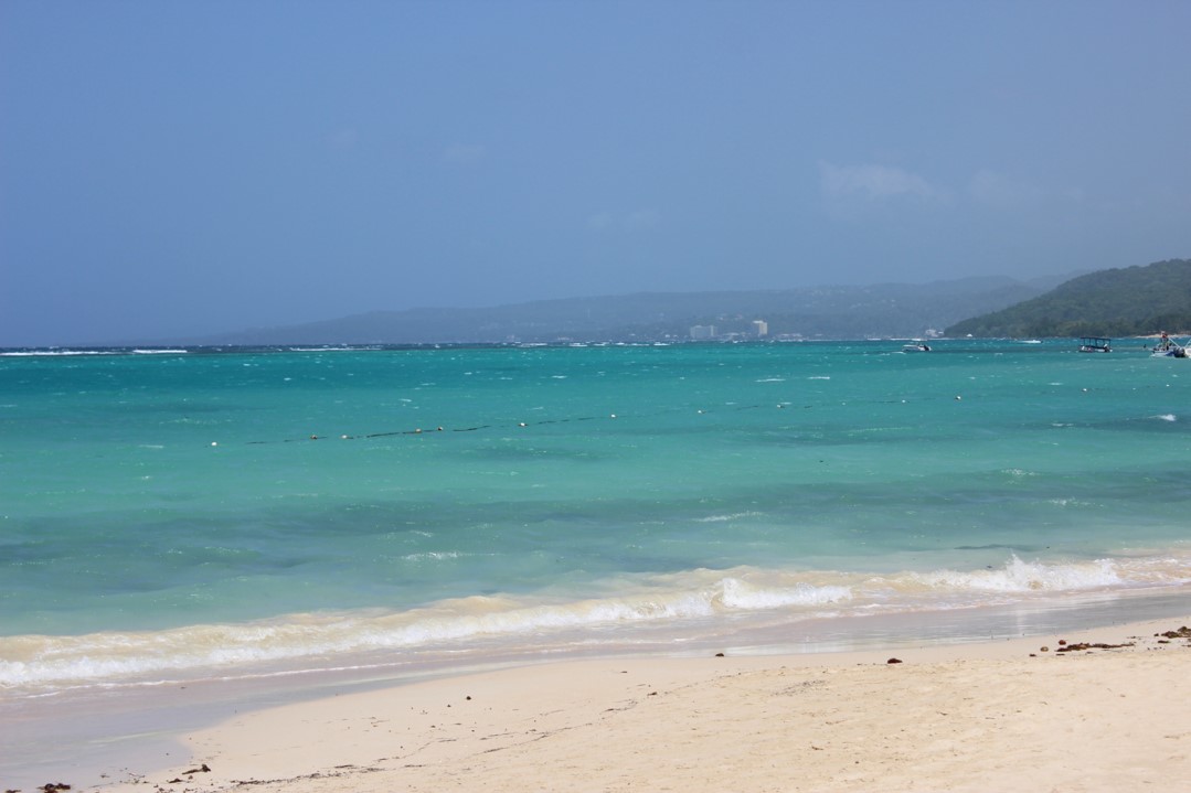 Jamaican beach at a resort on a hot sunny day. By following the proper tips for digital photography it is easy to taken beautiful vacation digital photos such as this one.