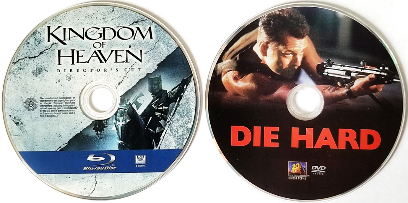 A Blu ray movie disc on the left (Kingdom of Heaven) and a DVD movie disc on the right (Die Hard). There are many differences when comparing Blu ray vs DVD.