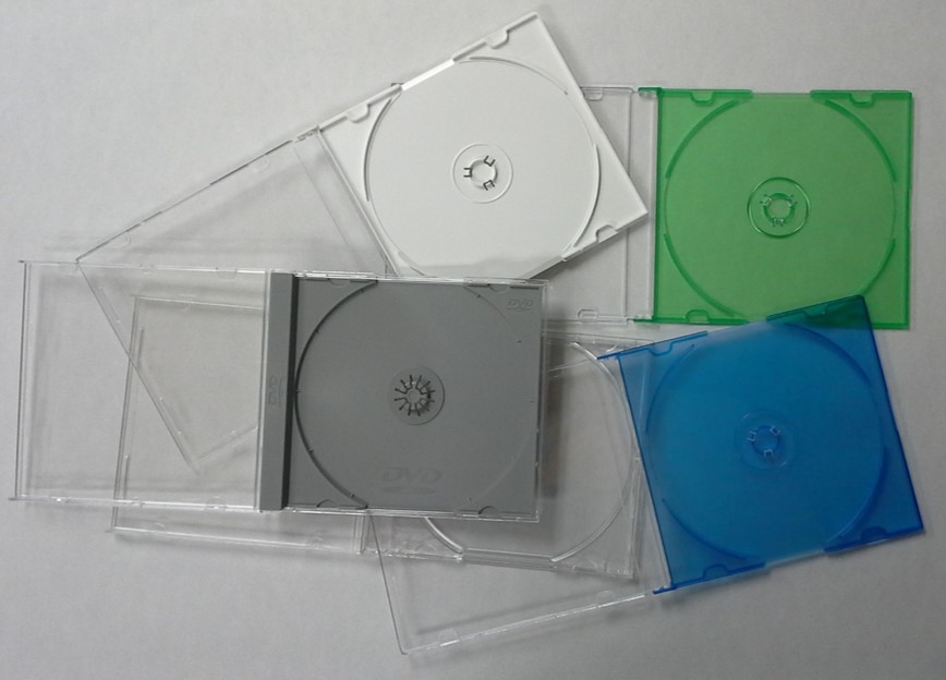 A variety of CD storage cases or jewel cases, for storing CDs and other optical discs, with different colored holding trays such as blue, green, grey, and white.
