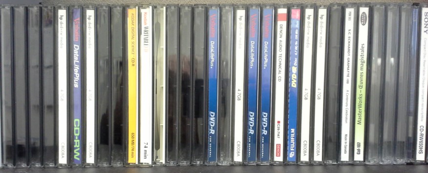 Vertical storage of jewel cases on a shelf is the proper storage orientation in order to prevent damage to the optical discs stored inside.