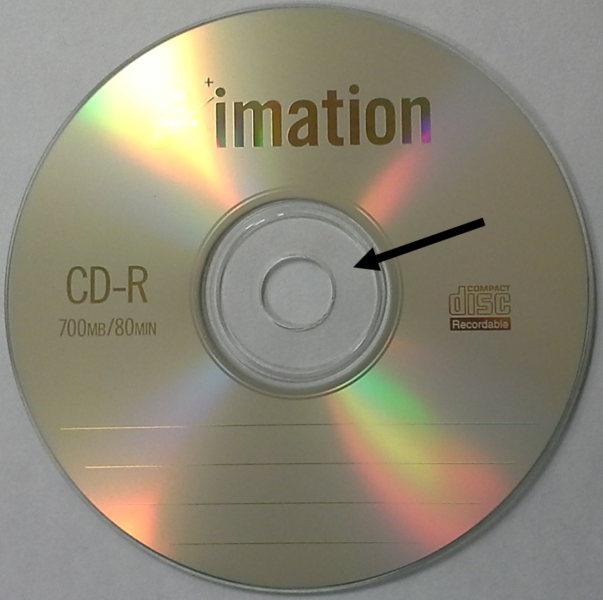 Clear hub area of a CD-R disc by Imation indicated by the black arrow. When labeling optical discs with a marking pen, it is best to only write in this area to prevent possible disc damage.