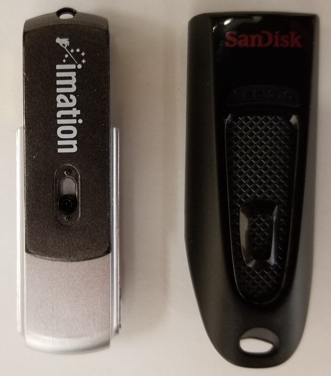 Two USB flash drives with the connector interface protected. On the left, a swivel portion of the shell provides protection. On the right the connector is retracted into the shell.