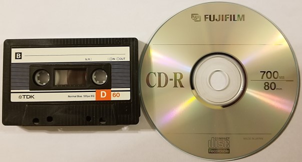 An audio cassette tape and a recordable CD or CD-R. Conversion of the analog cassette to digital form, either a CD-R or digital file, is necessary for preservation of the content.