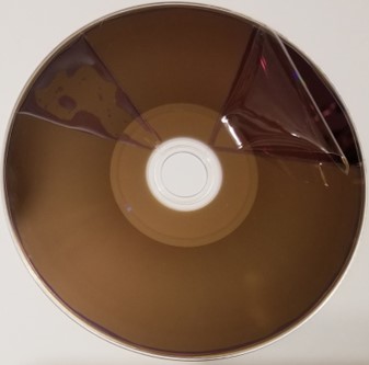 Hard coat layer peeled off of a BD-R or recordable Blu-ray disc. The hard coat layer provides extra protection against scratches, dust and dirt, and fingerprints.