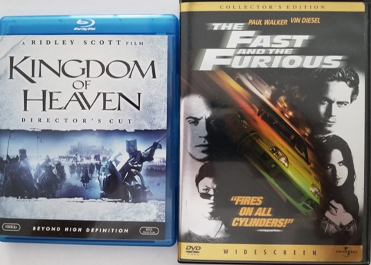 A Blu-ray movie disc (Kingdom of Heaven) and DVD movie disc (The Fast and the Furious), both of which may contain hidden Blu-ray and DVD Easter eggs.