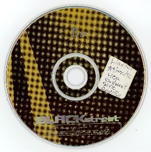A partial adhesive or sticky paper label placed on the top surface of an audio CD.