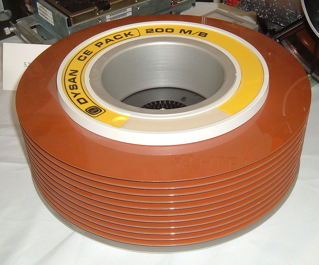 A stack of old hard disks used before the 1980s. Note the brown magnetic oxide color of the disks. Several disks were required in one pack to have a reasonable amount of storage capacity.