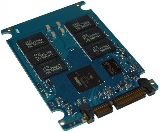 An opened solid state drive or SSD showing several black memory chips,  which store the information.